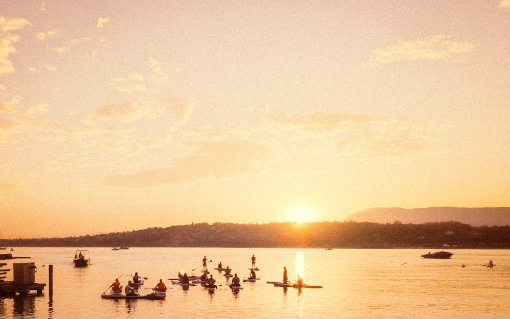 a group of people on small boats in a body of water