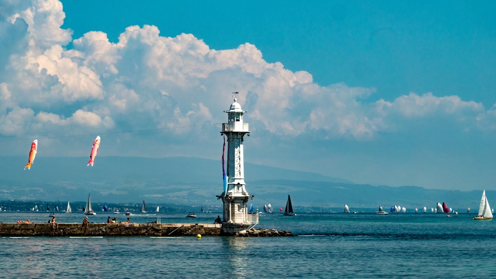 a light house sitting on top of a body of water