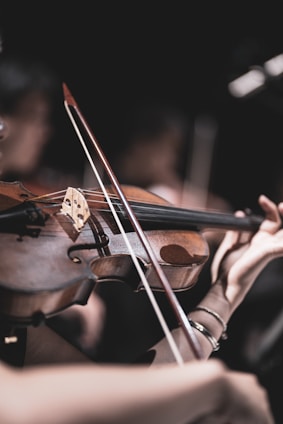 a close up of a person playing a violin