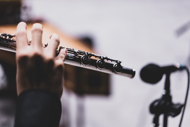 a close up of a person holding a flute