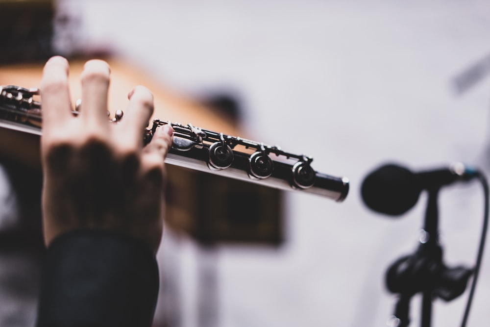 a close up of a person holding a flute