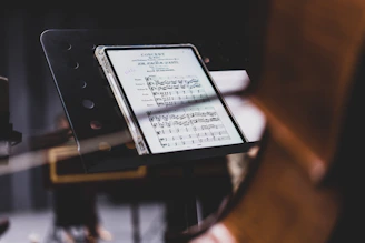 Close-up of digital sheet music displayed on a sleek tablet with dark mode interface.