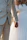 Close-up of a couple holding hands with soft sunlight in the background during their wedding video session.