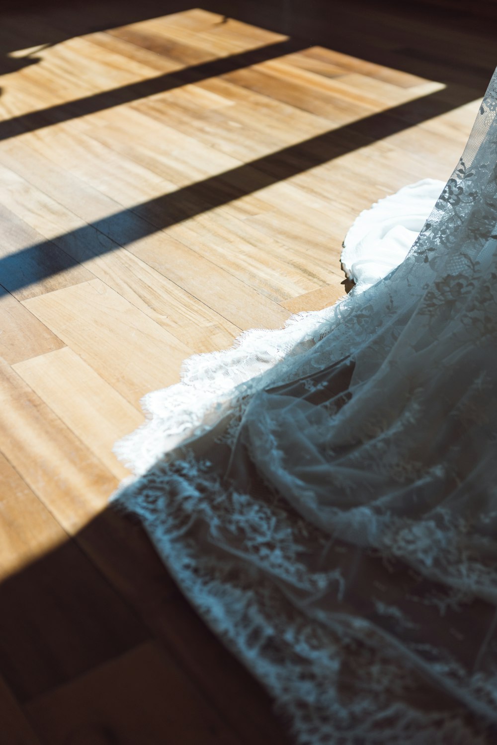 a wedding dress on a wooden floor in a room