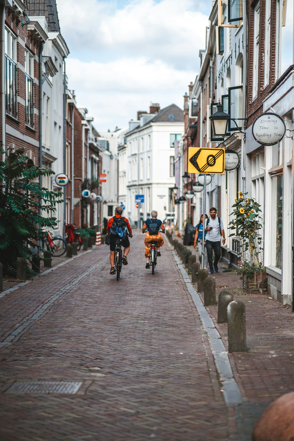 a couple of people riding bikes down a street