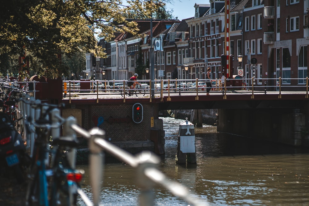 a bridge over a body of water with bicycles parked on it