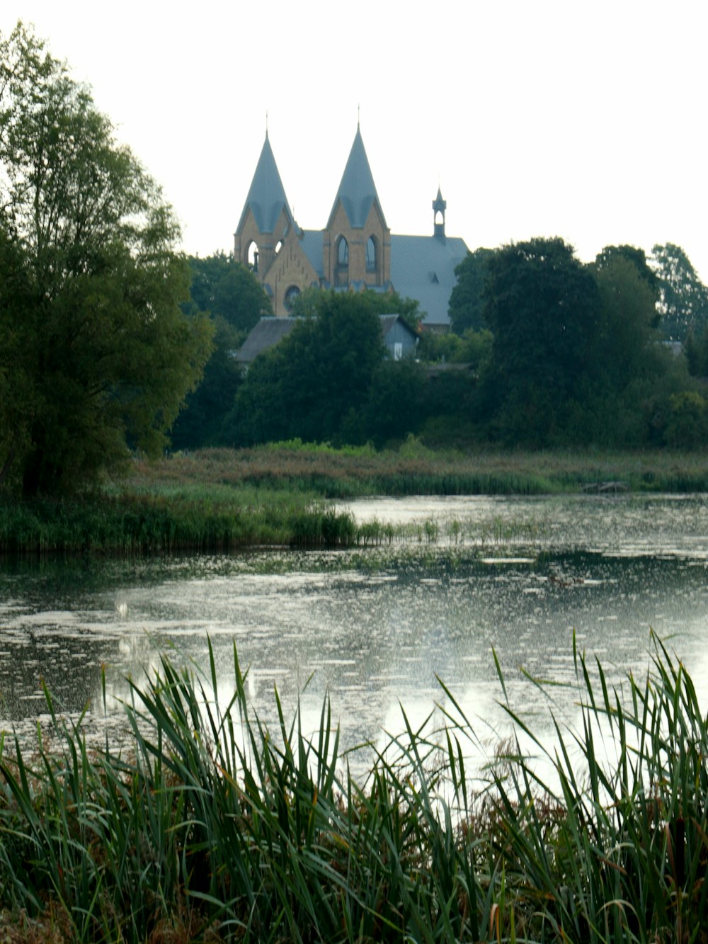 a lake with a church in the background