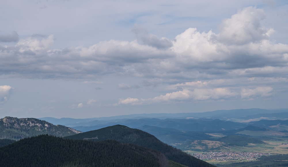 a view of a mountain range with clouds in the sky