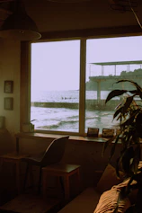 Cozy guest room with large windows overlooking Lake Toba at sunrise.