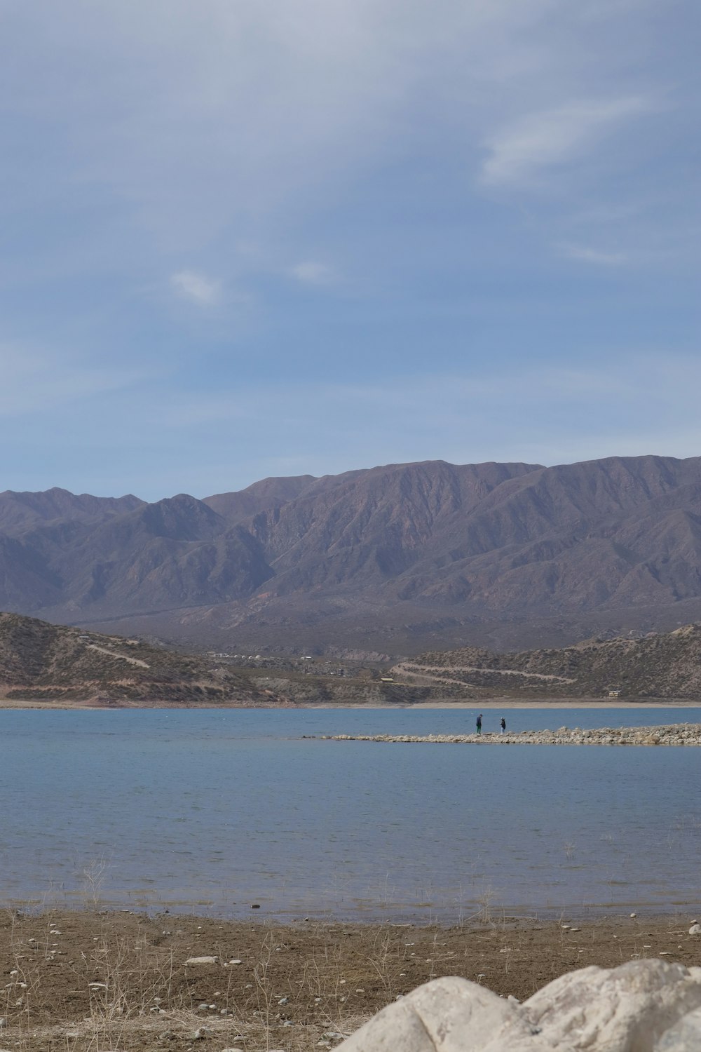 a large body of water with mountains in the background