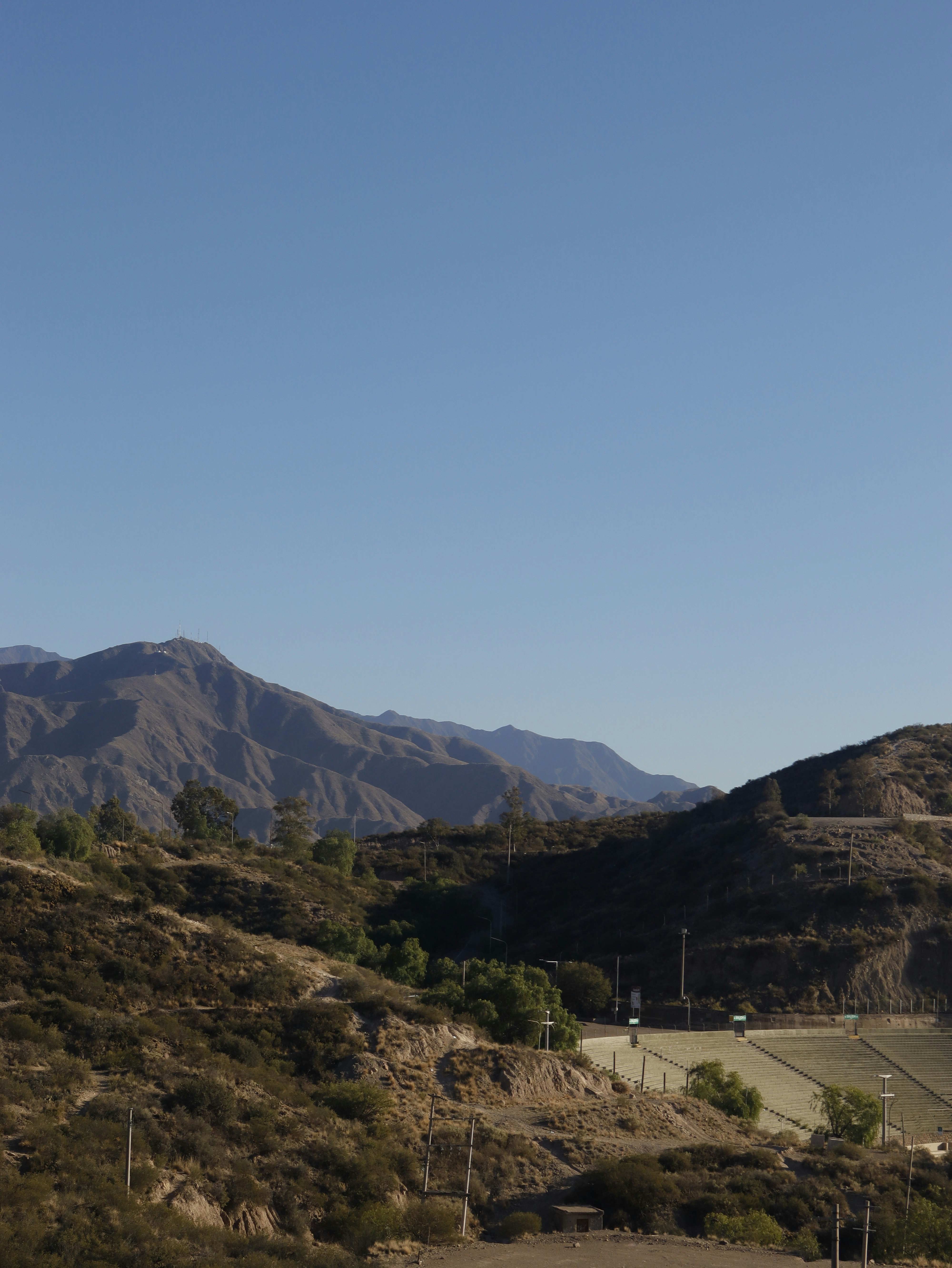 a view of a mountain range with a road in the foreground