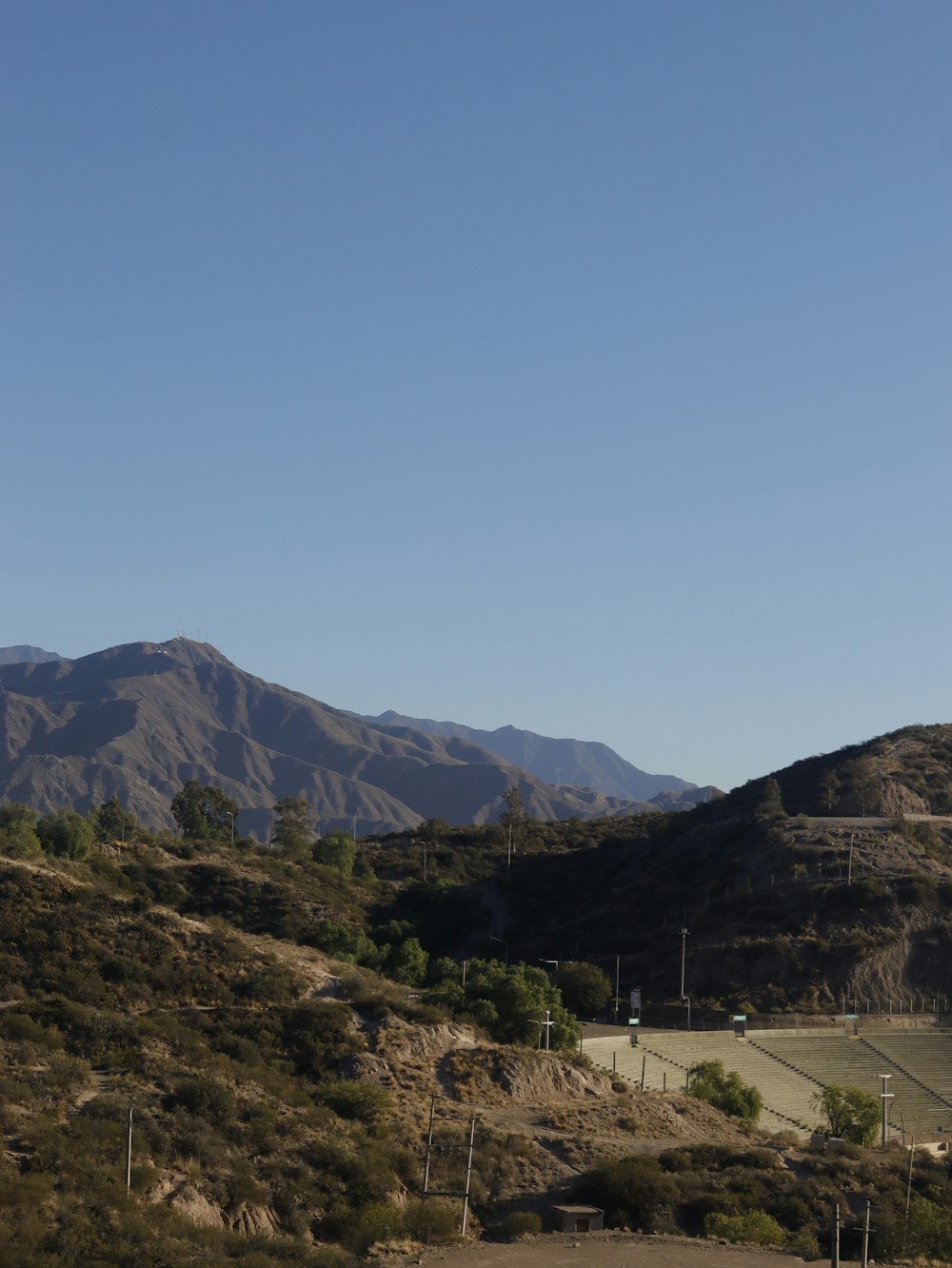 a view of a mountain range with a road in the foreground