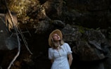 a woman in a white dress and a straw hat