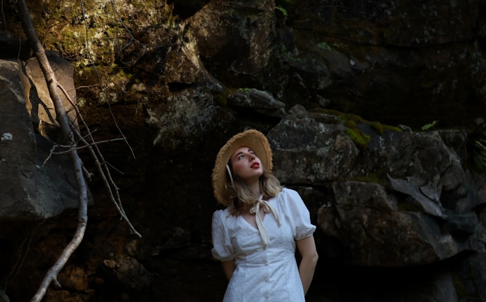 a woman in a white dress and a straw hat