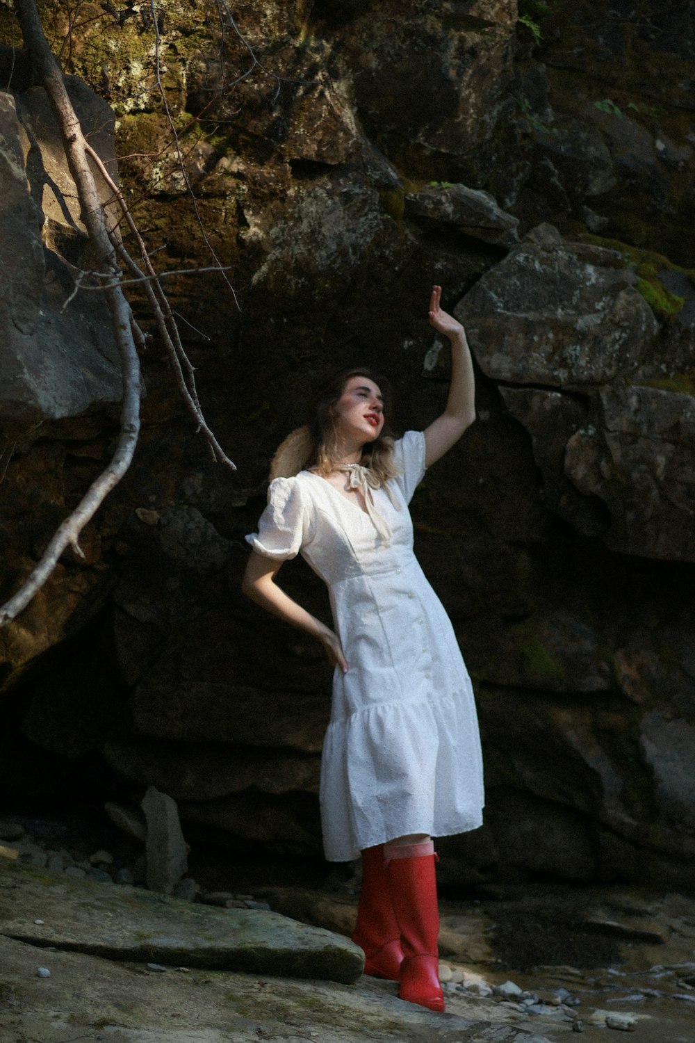 a woman in a white dress and red boots