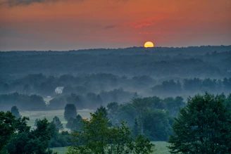 A serene meditation retreat surrounded by nature at sunset