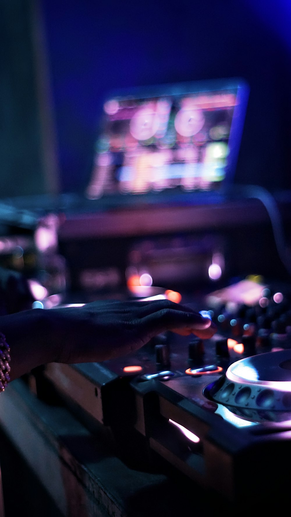 a dj mixing music in front of a laptop