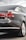 The image captures the rear view of a sleek, dark-colored sedan with tinted windows. The car appears modern and well-maintained, showcasing its taillights, rear badge indicating '2.0 TDI', and a clean, reflective surface with minor reflections.