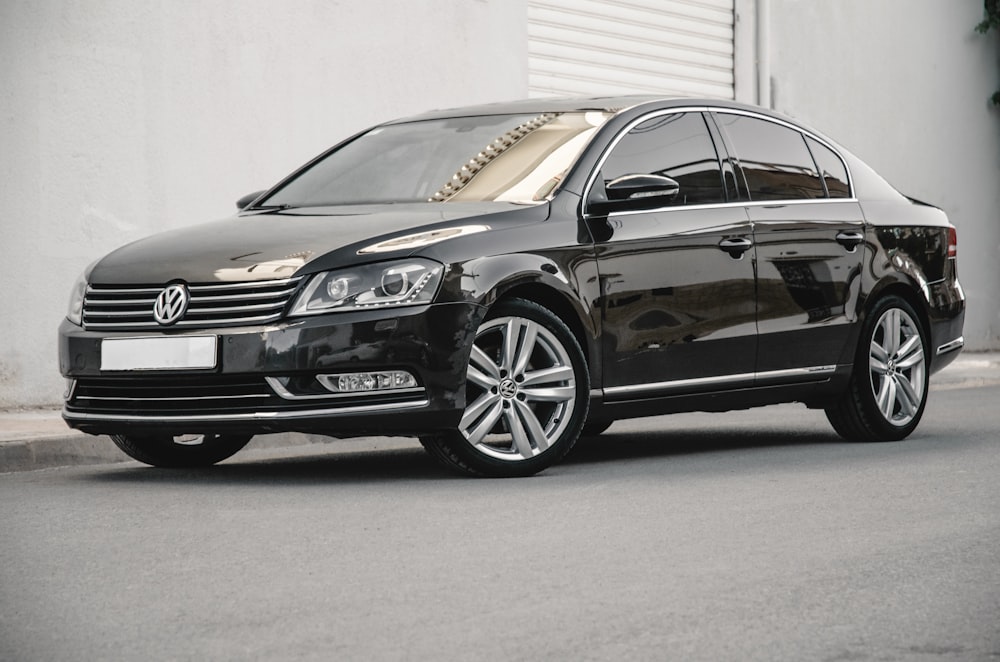 a black car parked in front of a building