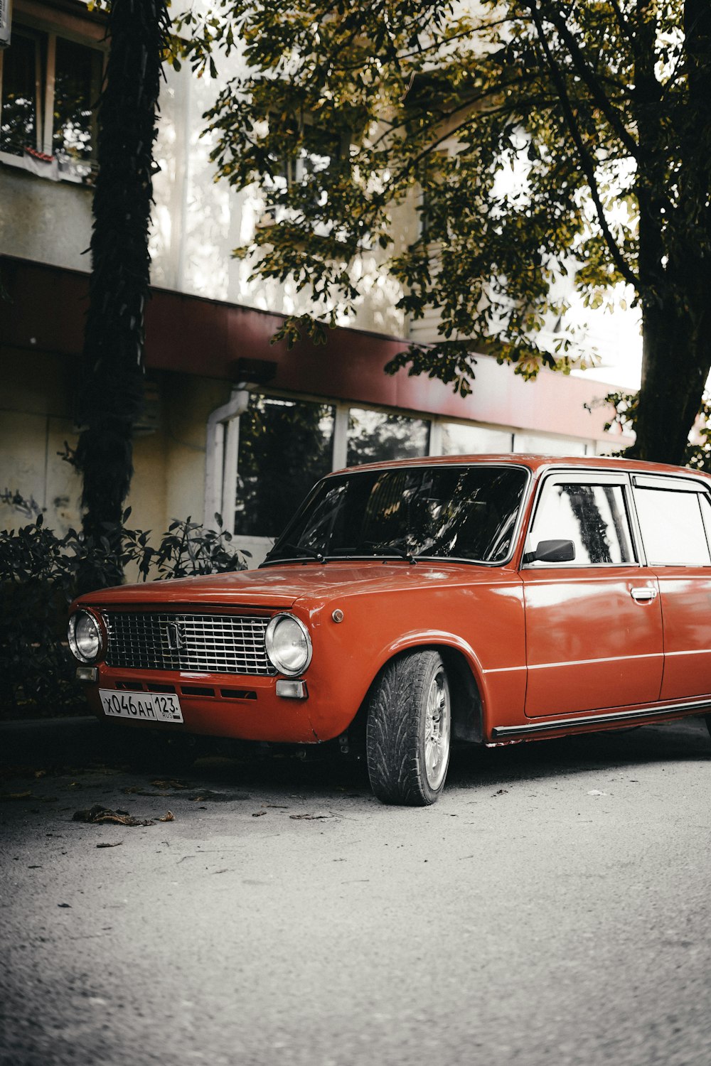 an orange car parked on the side of the road