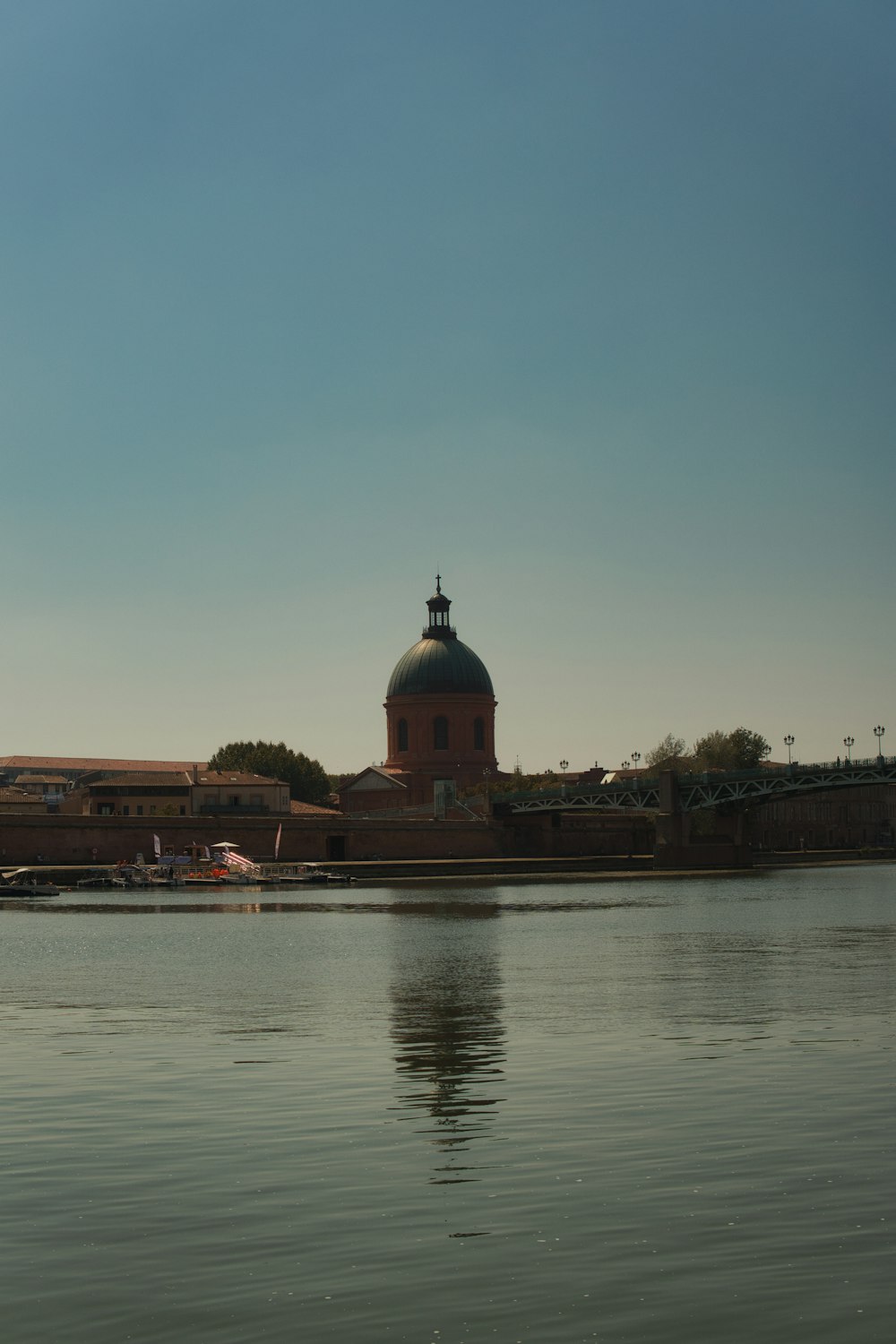 a large body of water with a building in the background