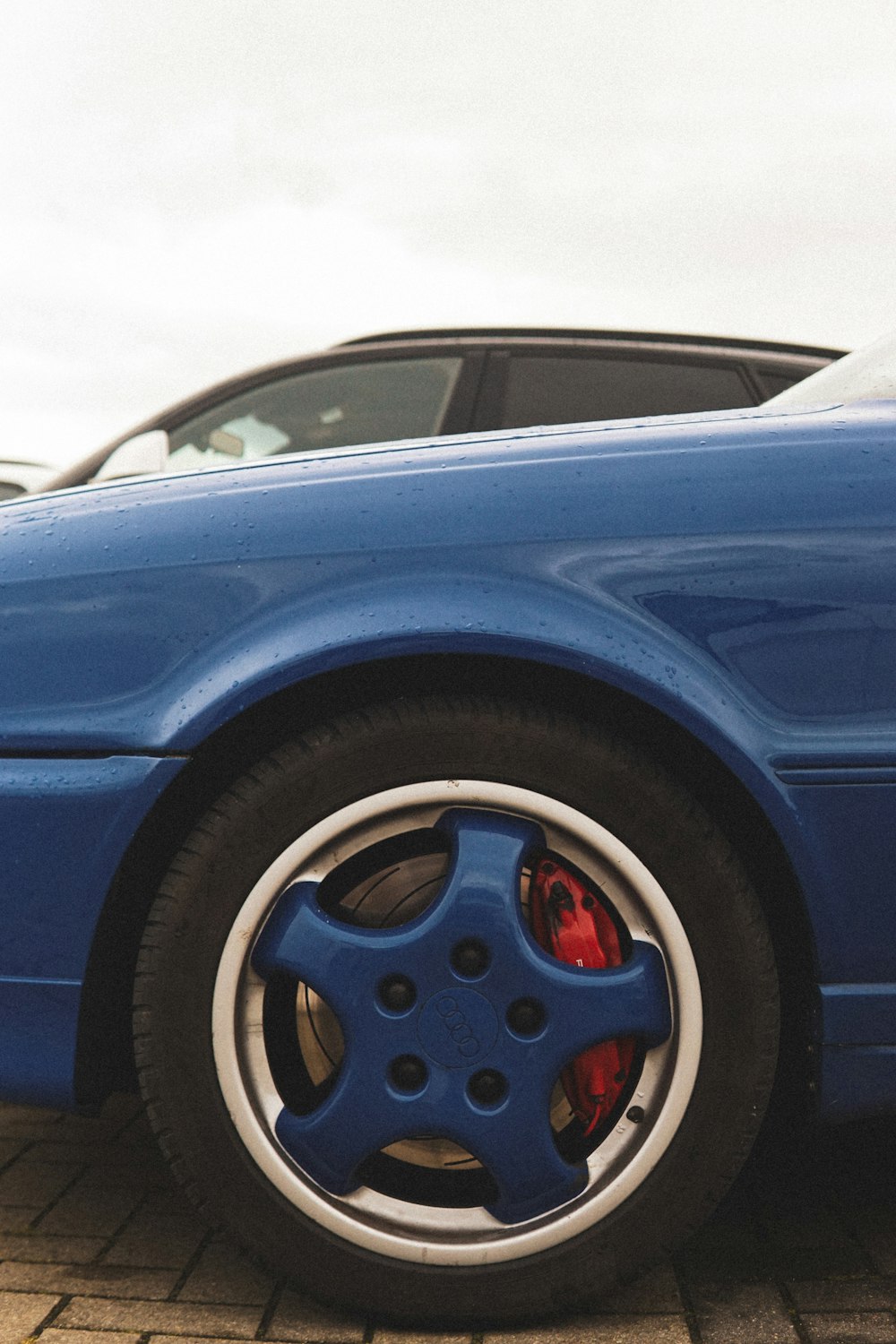 a blue sports car parked in a parking lot