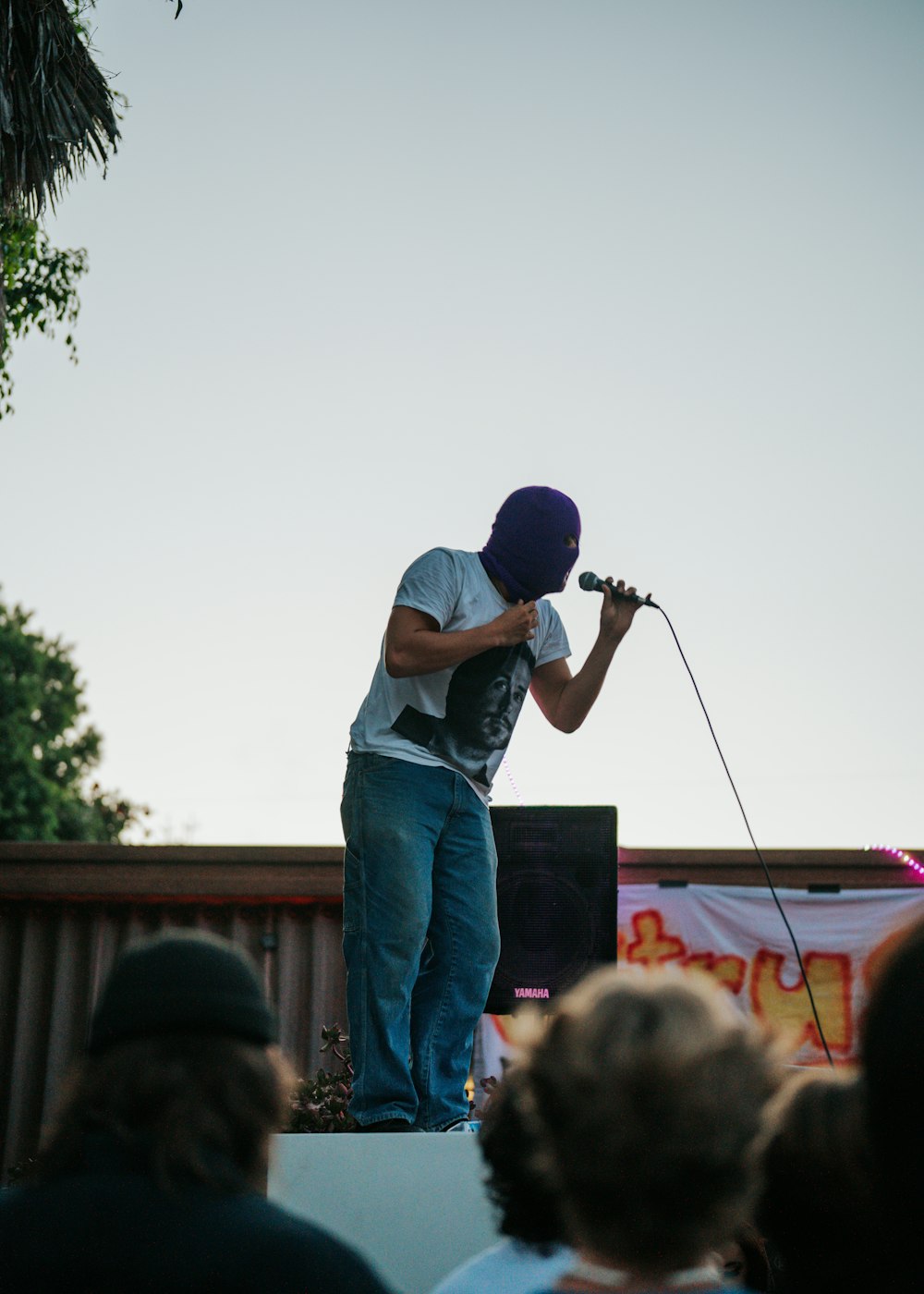 a man standing on top of a stage holding a microphone