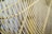 Close-up view of a series of parallel, curved metal bars forming a grid-like pattern, possibly part of a fan or protective guard.