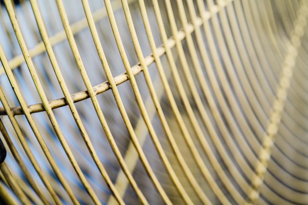 a close up of a metal fence with a blurry background