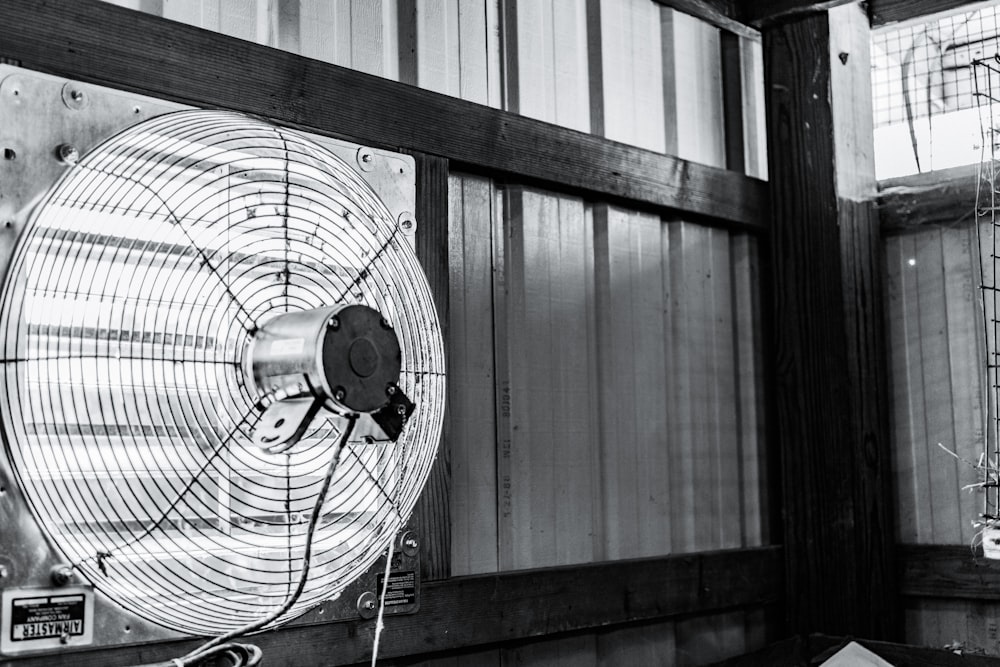 a black and white photo of a fan in a room