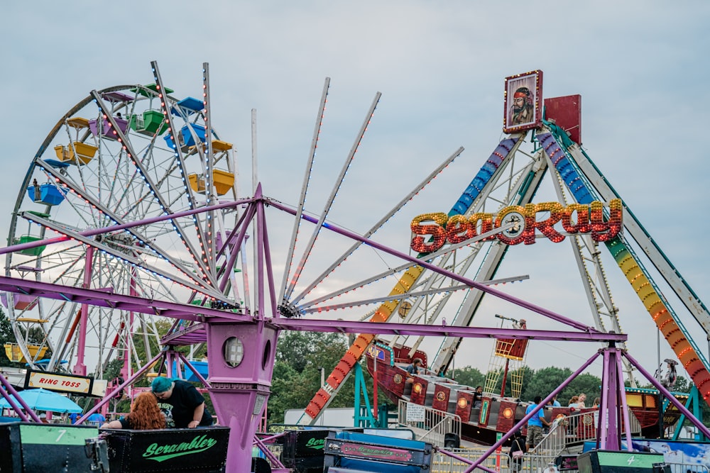 a carnival ride with a ferris wheel in the background