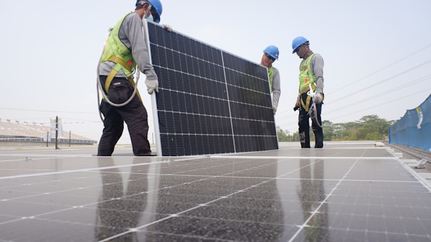 Technicians installing solar equipment at a commercial site.