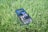 Lush green lawn freshly mowed with a smartphone showing Juno app notifications.