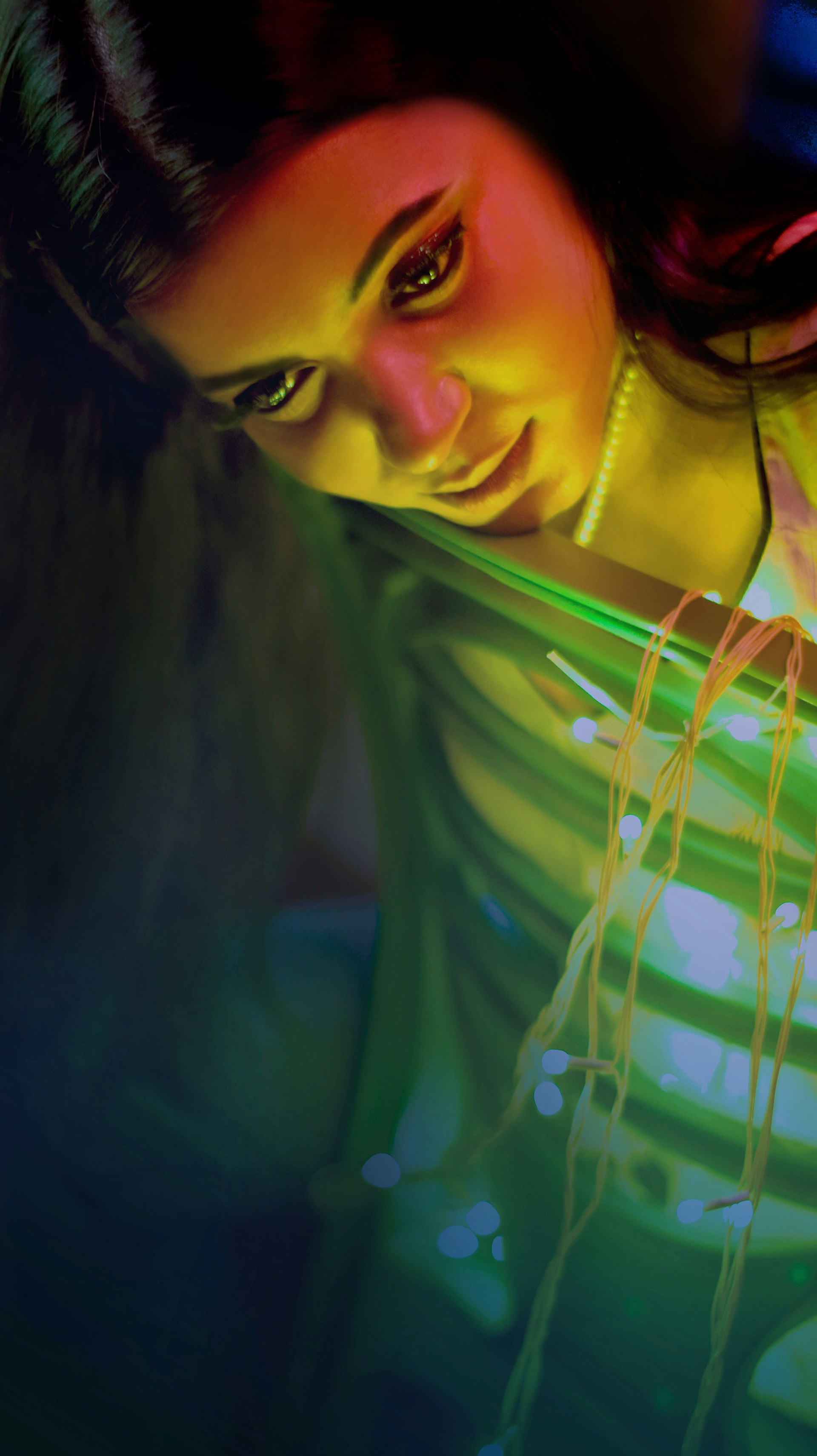 A vibrant still from Jordyn Hill's latest reel, showcasing her expressive acting with a soft pink and gold backdrop.