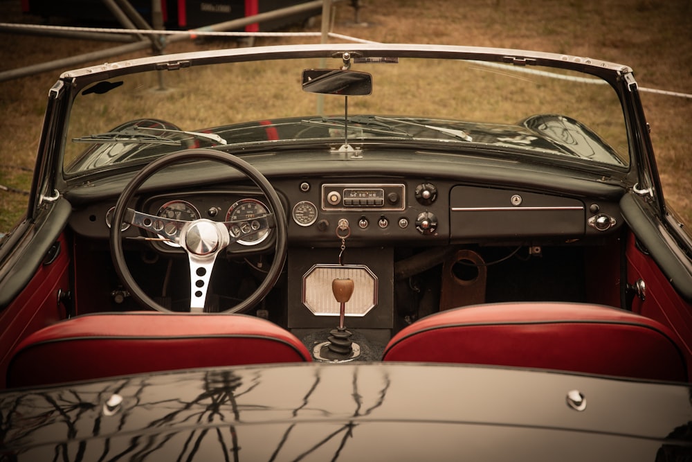 a car dashboard with a steering wheel and a dash board