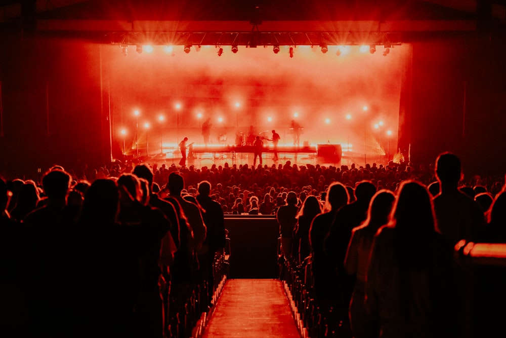 a crowd of people watching a concert on stage