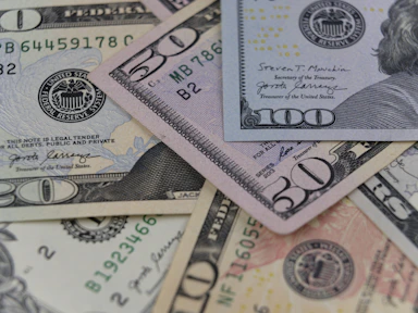 a pile of twenty dollar bills laying on top of each other