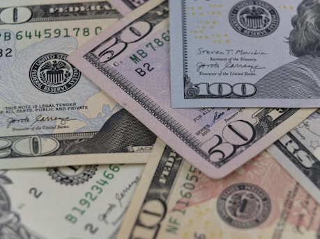 a pile of twenty dollar bills laying on top of each other