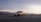 A rugged SUV parked near a scenic Lusaka roadside with a sunset backdrop.