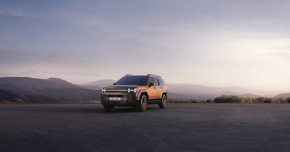 Tata Sierra SUV parked on a rugged mountain trail during golden hour, highlighting its bold silhouette.