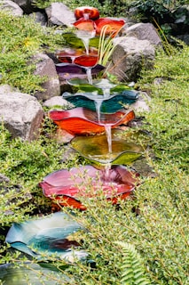 A collection of garden decor pieces made from fiberglass, blending art with nature in a tranquil outdoor space.