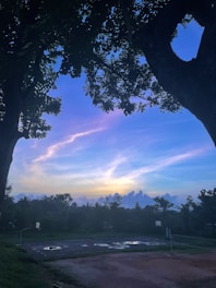 A vibrant basketball court scene with players enjoying a casual game under sunset lighting.