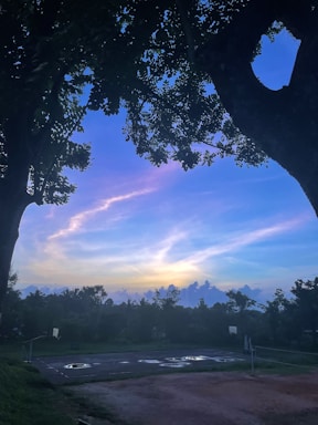A warm, inviting photo of a basketball court at sunset, symbolizing connection and community.