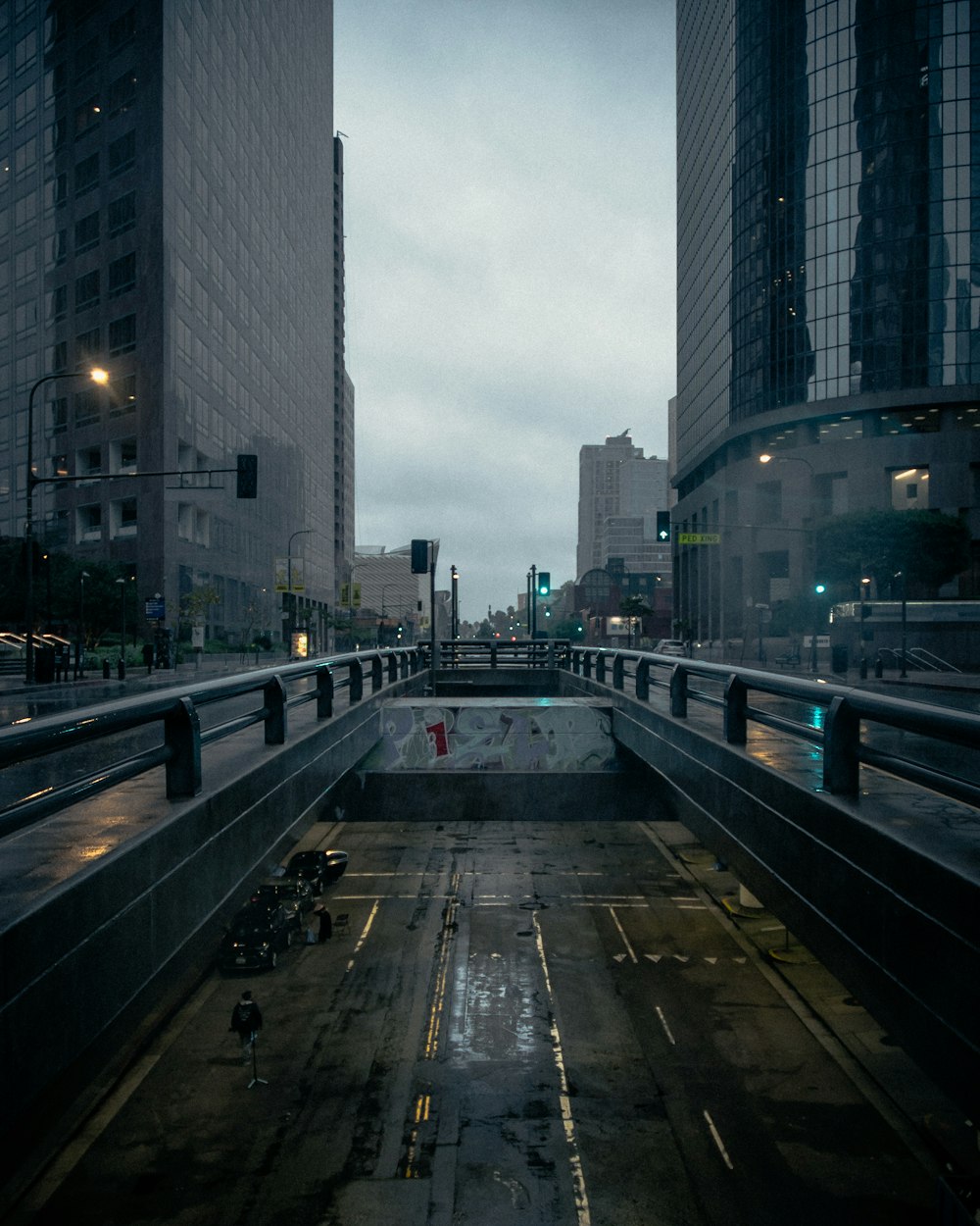 a city street at night with rain on the ground