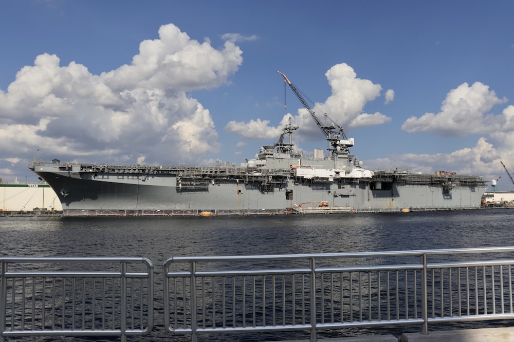 a large military ship docked in the water