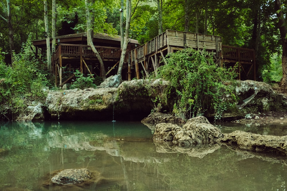 a wooden bridge over a river in a forest