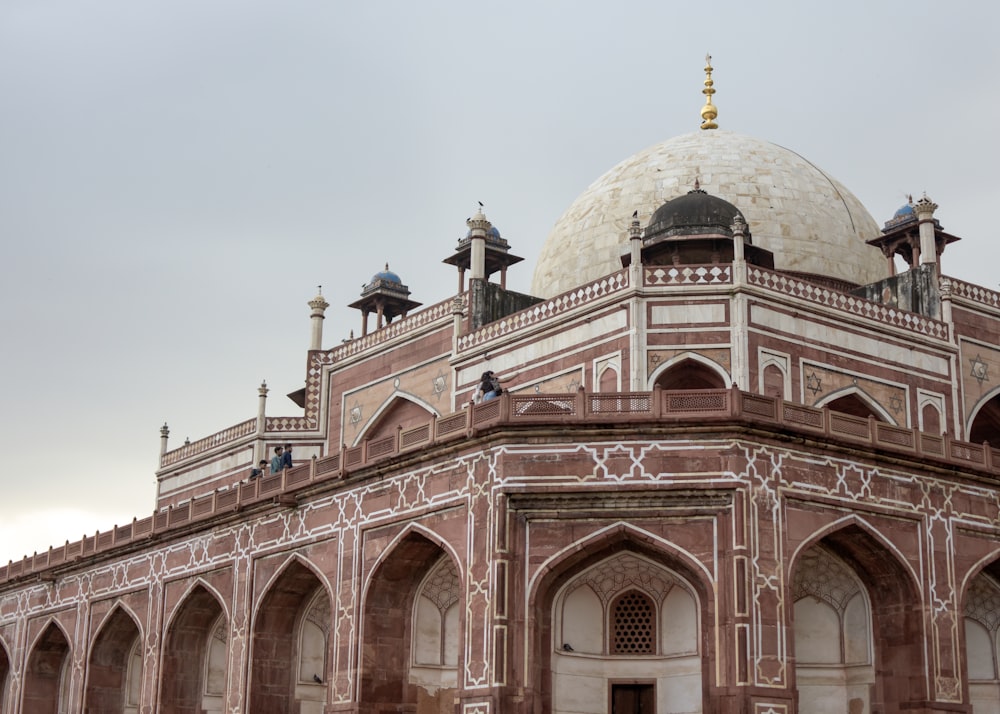 a large white and brown building with a dome