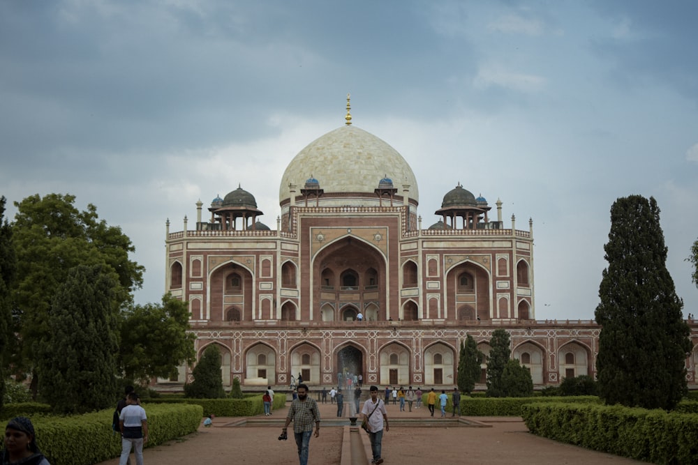 a group of people walking in front of a building