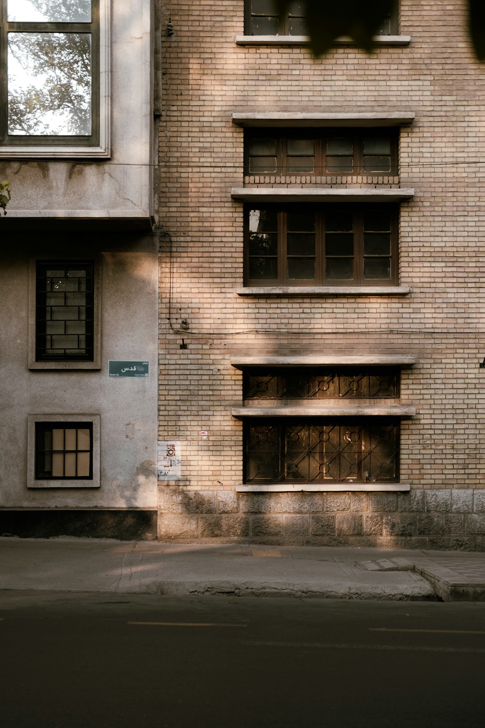 a tall brick building sitting next to a street