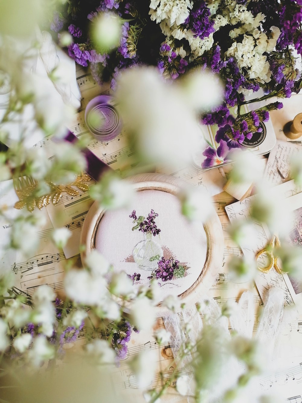 a table topped with lots of purple and white flowers